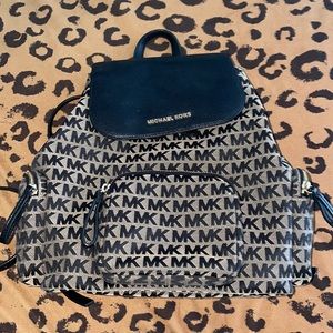 Black and tan MK backpack.